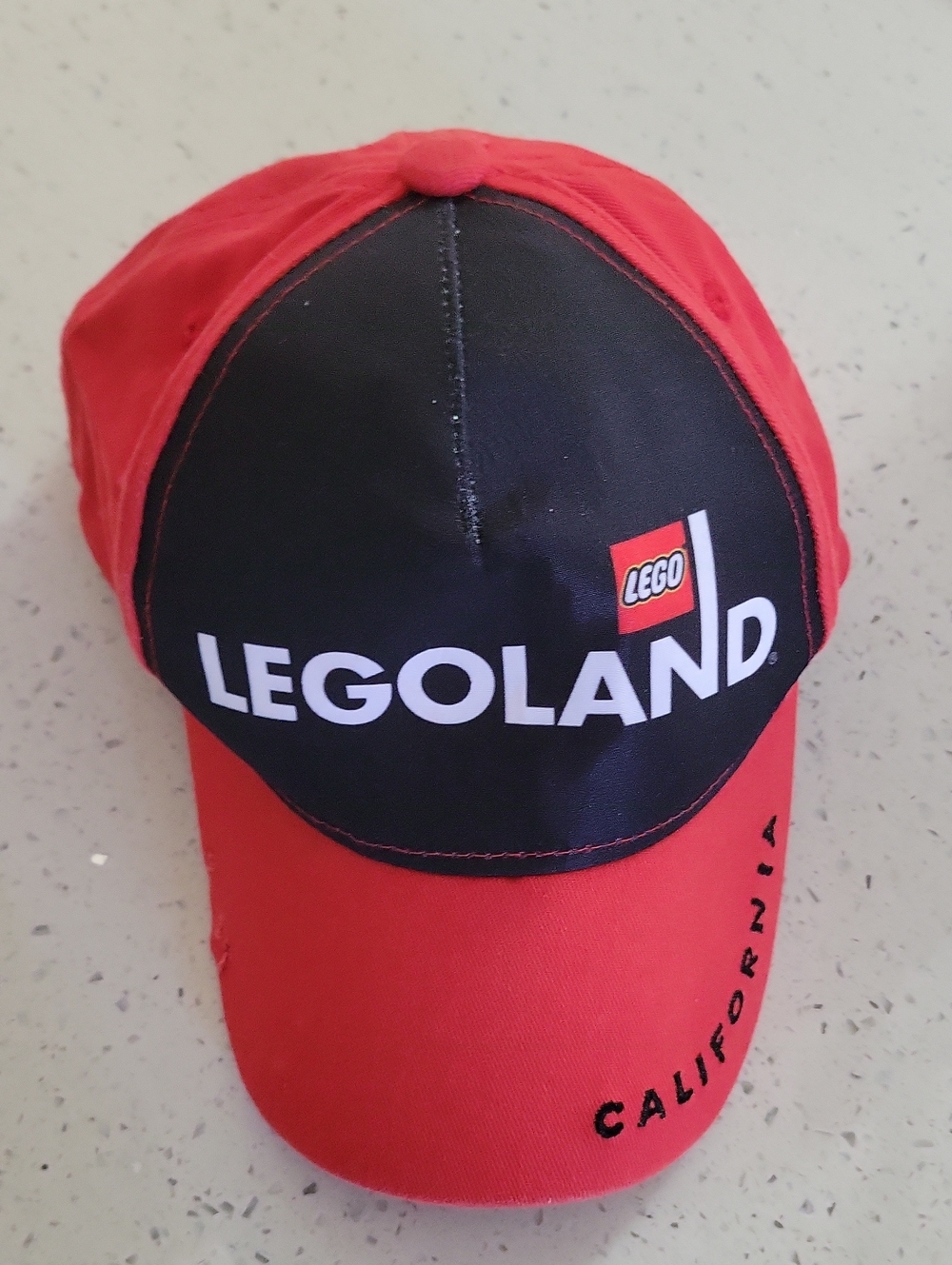 Legoland Logo Baseball Cap in Red and Black. YOUTH Size.